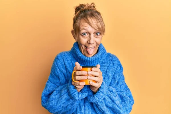 Middle Age Blonde Woman Drinking Cup Coffee Sticking Tongue Out — Stock Photo, Image