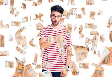 Gündelik giysiler giyen genç İspanyol adam parmaklarını yana doğru göstererek şaşırdı, ağzı açık hayret içinde kaldı..