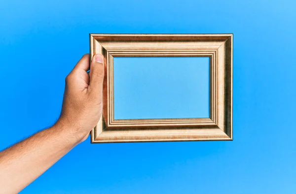 Hand Young Hispanic Man Holding Vintage Empty Frame Isolated Blue — Stock Photo, Image