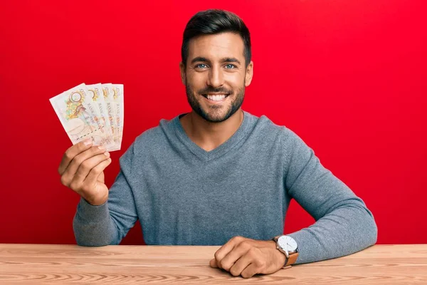 Hombre Hispano Guapo Sosteniendo Libras Del Reino Unido Mirando Positivo —  Fotos de Stock