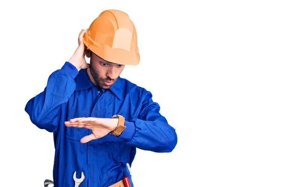 Young Hispanic Man Wearing Worker Uniform Looking Watch Time Worried — Stock Photo, Image