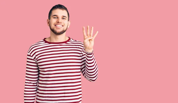 Jovem Homem Bonito Vestindo Camisola Listrada Mostrando Apontando Para Cima — Fotografia de Stock