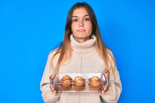 Beautiful Caucasian Woman Holding Homemade Muffins Depressed Worry Distress Crying — Stock Photo, Image