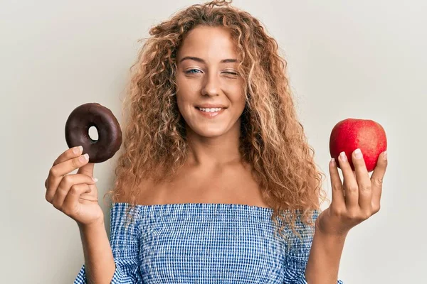 Όμορφη Καυκάσια Έφηβη Κοπέλα Κρατώντας Κόκκινο Μήλο Και Ντόνατ Κλείνει — Φωτογραφία Αρχείου