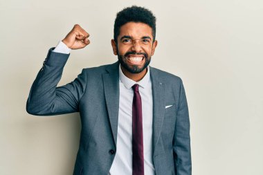 Yakışıklı İspanyol takım elbiseli ve kravatlı genç adam kollarını kavuşturup arkaya bakıyordu. 