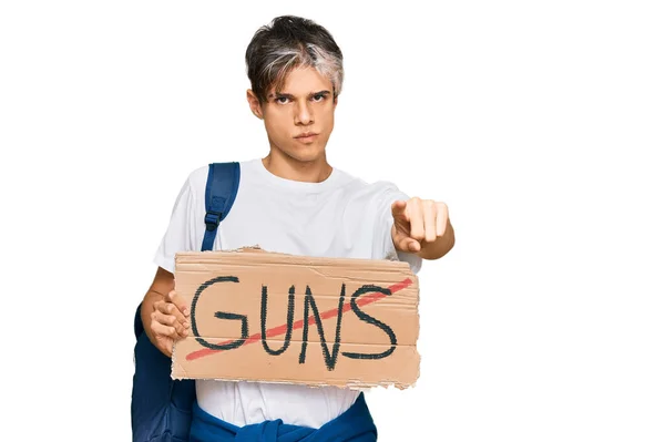 Young Hispanic Man Holding Guns Warning Banner Pointing Finger Camera — Stock Photo, Image