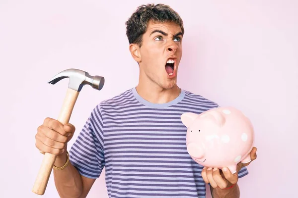 Young Handsome Man Holding Piggy Bank Hammer Angry Mad Screaming — Stock Photo, Image