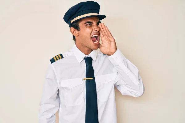 Joven Hombre Hispano Con Uniforme Piloto Avión Gritando Gritando Fuerte —  Fotos de Stock