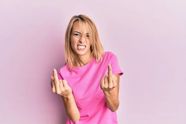 Beautiful Blonde Woman Wearing Casual Pink Tshirt Showing Middle Finger — 스톡 사진