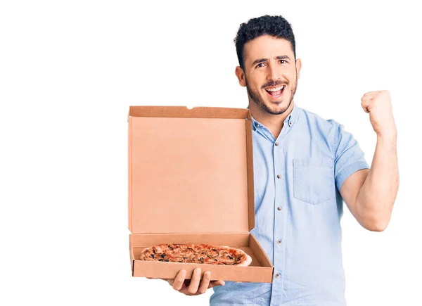 Young Hispanic Man Holding Delivery Pizza Box Screaming Proud Celebrating — Stock Photo, Image
