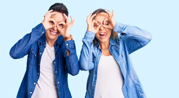 Couple Women Wearing Casual Clothes Doing Gesture Binoculars Sticking Tongue — Stockfoto
