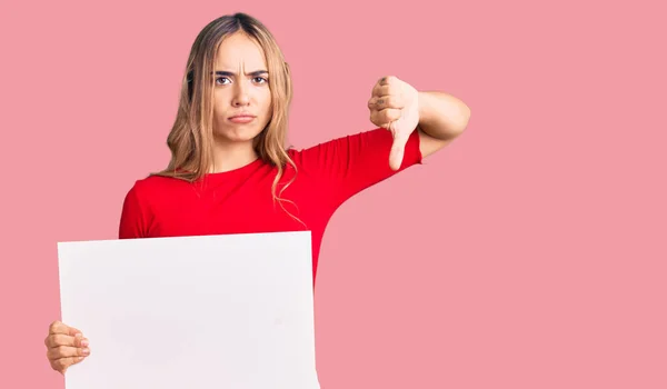 Young Beautiful Blonde Woman Holding Blank Empty Banner Angry Face — Stock Photo, Image