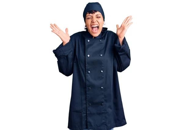 年轻的黑发女子身穿职业厨师制服 高举双臂 紧闭双眼 兴奋地尖叫着 庆祝成功 获奖者概念 — 图库照片