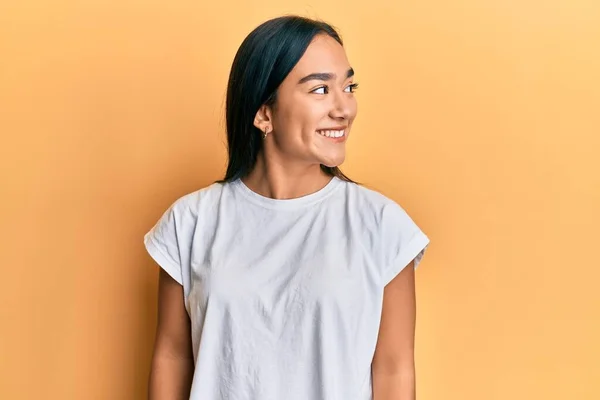 stock image Young asian woman wearing casual white t shirt looking to side, relax profile pose with natural face and confident smile. 