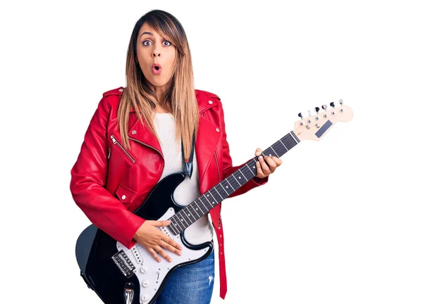 Young Beautiful Woman Playing Electric Guitar Scared Amazed Open Mouth — Stock Photo, Image