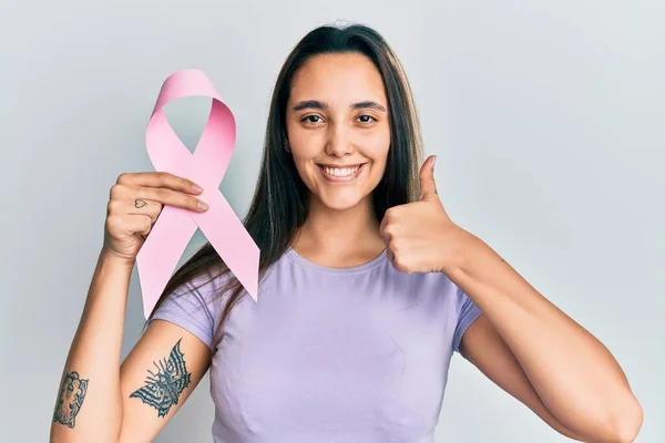 Mulher Hispânica Jovem Segurando Fita Câncer Rosa Sorrindo Feliz Apontando — Fotografia de Stock