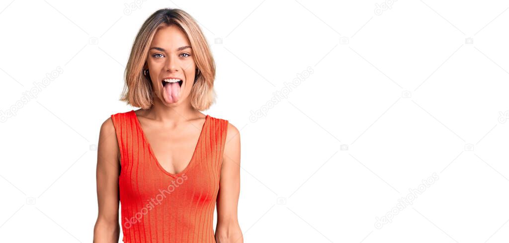 Beautiful caucasian woman wearing casual clothes sticking tongue out happy with funny expression. emotion concept. 