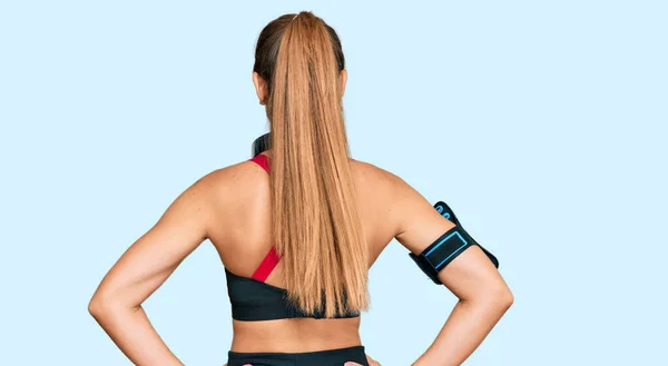 Vacker Blond Kvinna Gympakläder Och Med Hörlurar Som Står Baklänges — Stockfoto