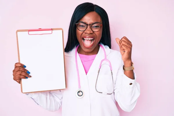 Junge Afroamerikanerin Trägt Doktor Stethoskop Mit Klemmbrett Und Schreit Stolz — Stockfoto