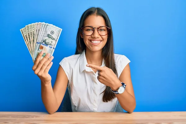 Beautiful Hispanic Woman Holding Dollars Smiling Happy Pointing Hand Finger — Stock Photo, Image