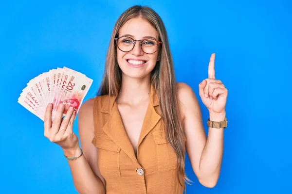 Jovencita Rubia Sosteniendo Shekels Israelíes Sorprendida Con Una Idea Pregunta —  Fotos de Stock