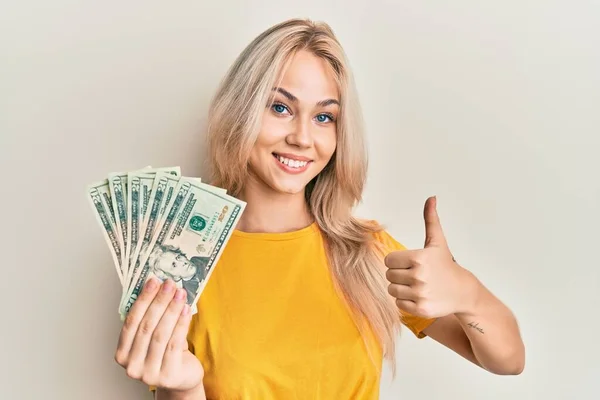 Beautiful Caucasian Blonde Girl Holding Dollars Banknotes Smiling Happy Positive — Stock Photo, Image