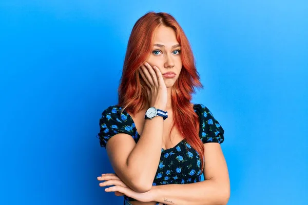 Junge Schöne Rothaarige Frau Lässiger Kleidung Vor Blauem Hintergrund Denkt — Stockfoto