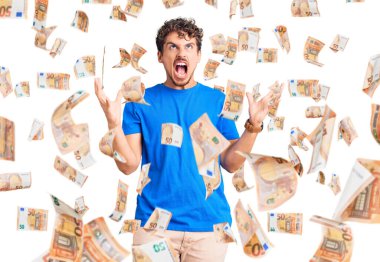 Kıvırcık saçlı, sıradan kıyafetler giyen, deli gibi bağıran, agresif ifade ve kollarıyla bağıran genç yakışıklı bir adam. hüsran kavramı.