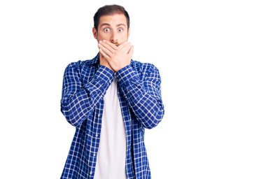Gündelik giysiler giyen yakışıklı beyaz adam yanlışlıkla elleri ile ağzını kapatırken şok oldu. gizli kavram. 