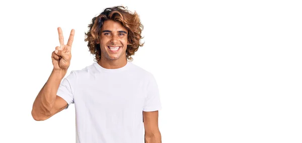 Young Hispanic Man Wearing Casual White Tshirt Showing Pointing Fingers — Stock Photo, Image