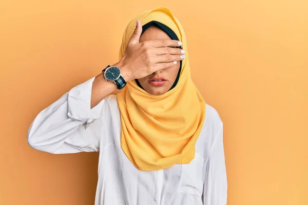 手で目をカバー伝統的なイスラムヒジャーブスカーフを身に着けている若いブルネットのアラブ女性は 真剣で悲しい探しています 目立たず隠し拒否の概念 — ストック写真