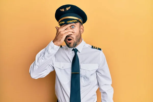 Hombre Hispano Guapo Vistiendo Uniforme Piloto Avión Asomándose Shock Cubriendo —  Fotos de Stock