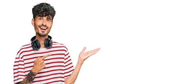 Молодий Іспаномовний Чоловік Слухає Музику Допомогою Навушників Здивований Посміхається Камері — стокове фото