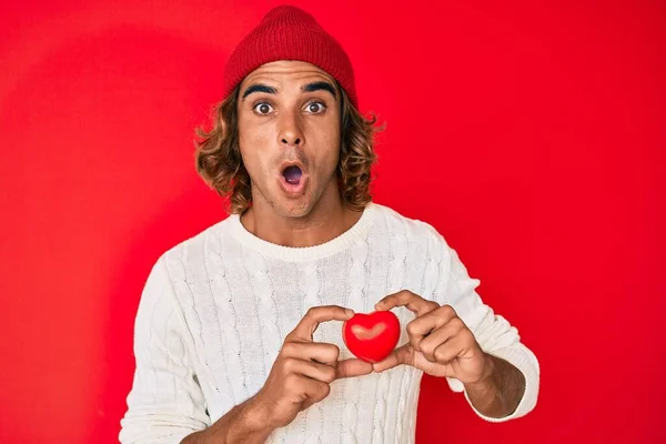 Young Hispanic Man Holding Heart Afraid Shocked Surprise Amazed Expression — Stock Photo, Image