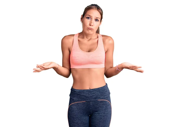 Young Beautiful Hispanic Woman Wearing Sportswear Clueless Confused Expression Arms — Stock Photo, Image