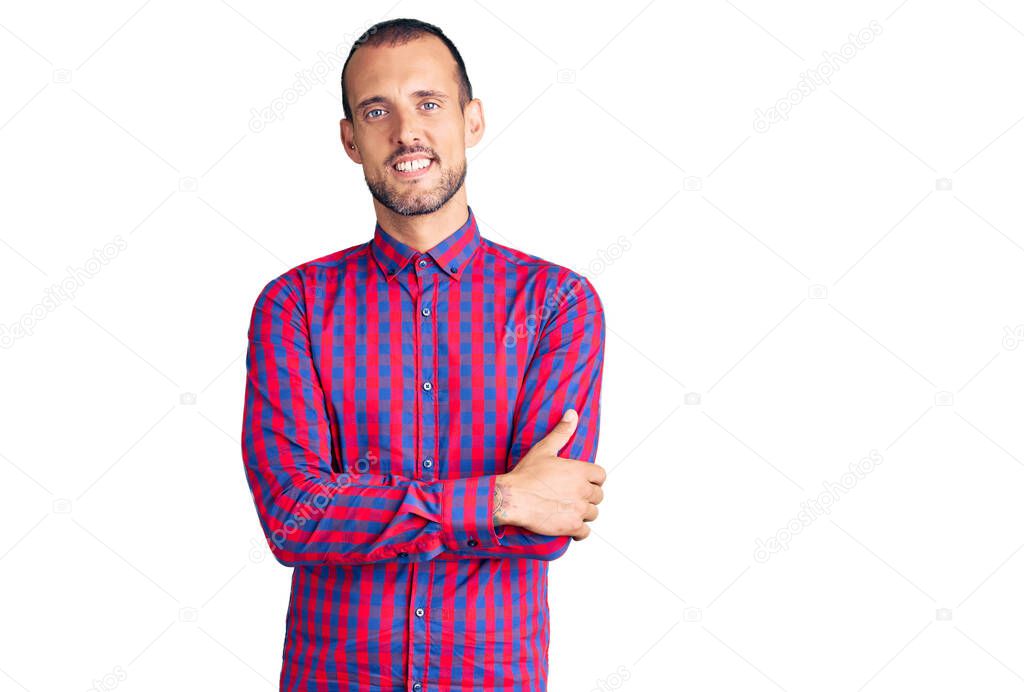 Young handsome man wearing casual clothes happy face smiling with crossed arms looking at the camera. positive person. 