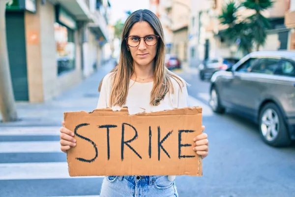 Young Caucasian Woman Serious Expression Holding Strike Banner Cardboard Standing — Stock Photo, Image