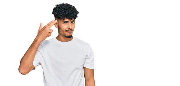 年轻的阿拉伯男子身穿随意的白色T恤 用枪指着自己的头和手指开枪自杀 — 图库照片