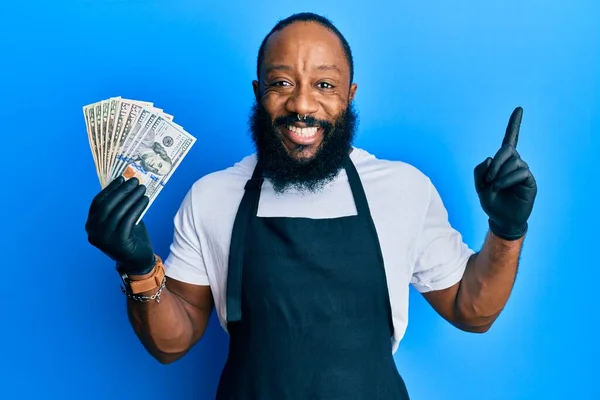 Young African American Man Wearing Professional Apron Holding Usa Dollars — Stock Photo, Image