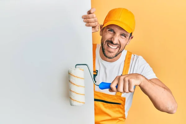 Young Handsome Man Holding Roller Painter White Banner Smiling Laughing — Stock Photo, Image