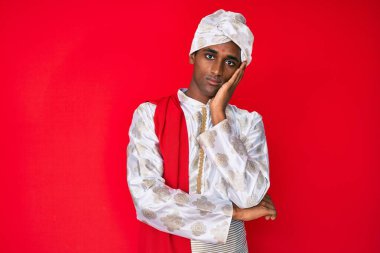 Handsome indian man wearing tradition sherwani saree clothes thinking looking tired and bored with depression problems with crossed arms. 