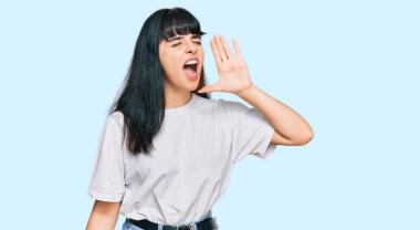 Latin asıllı genç bir kız günlük kıyafetler giyip el ele tutuşarak bağırıyor ve çığlık atıyordu. iletişim konsepti. 