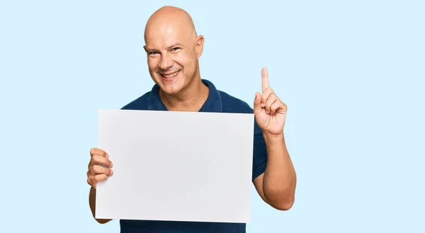 Middle Age Bald Man Holding Blank Empty Banner Surprised Idea — Φωτογραφία Αρχείου