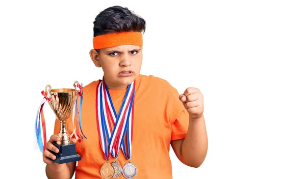Little Boy Kid Holding Champion Trophy Wearing Medals Annoyed Frustrated — Stok fotoğraf