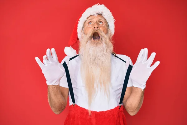 Old Senior Man Wearing Santa Claus Costume Suspenders Angry Mad — Zdjęcie stockowe