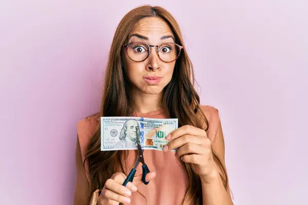 Young Brunette Woman Cutting Dollars Scissors Currency Devaluation Puffing Cheeks — Stockfoto