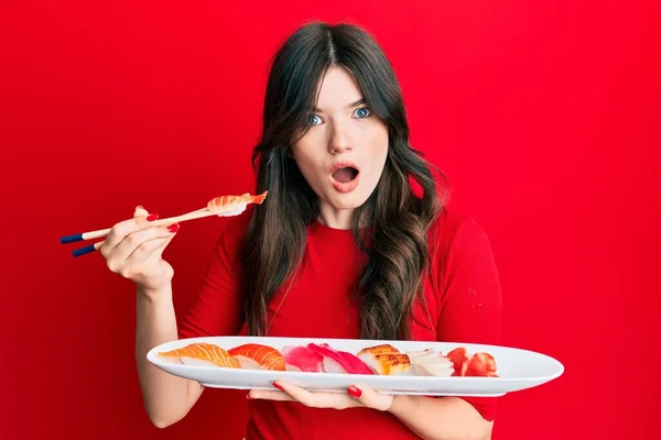 Joven Hermosa Chica Caucásica Comiendo Sushi Usando Palillos Cara Choque —  Fotos de Stock