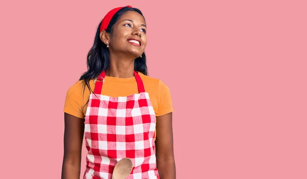 Young Indian Girl Wearing Professional Baker Apron Looking Away Side — Foto Stock