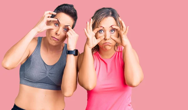 Couple Women Wearing Sportswear Trying Open Eyes Fingers Sleepy Tired — Stock Photo, Image