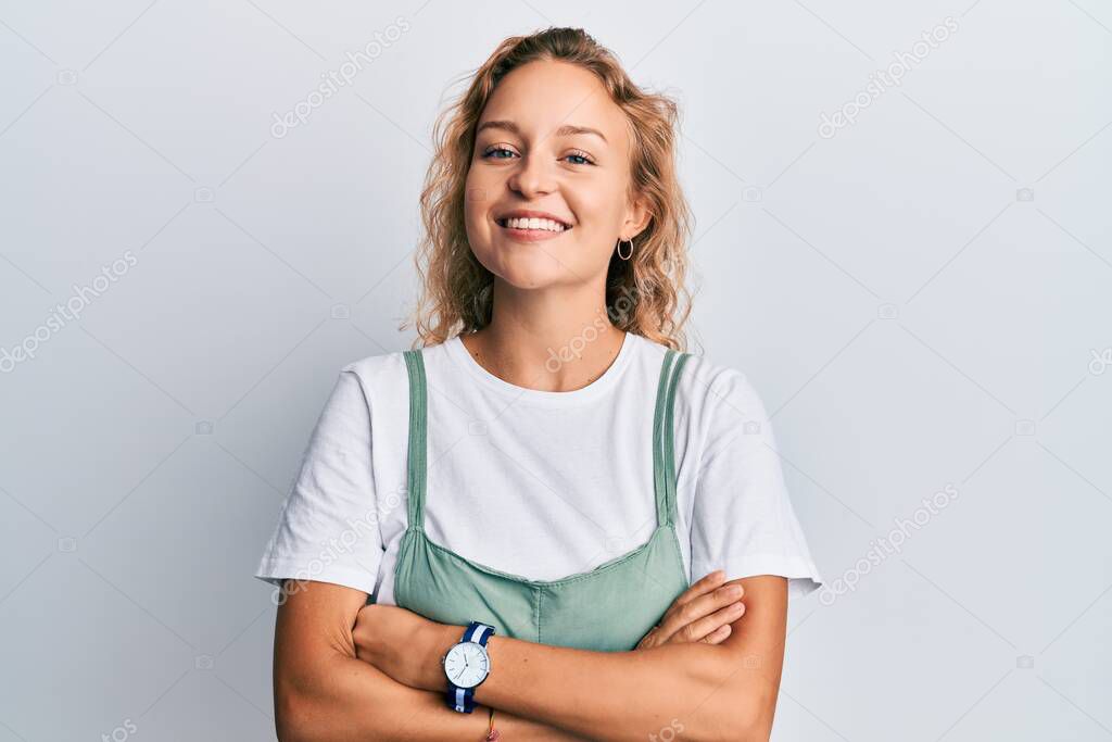 Beautiful caucasian woman wearing casual clothes happy face smiling with crossed arms looking at the camera. positive person. 